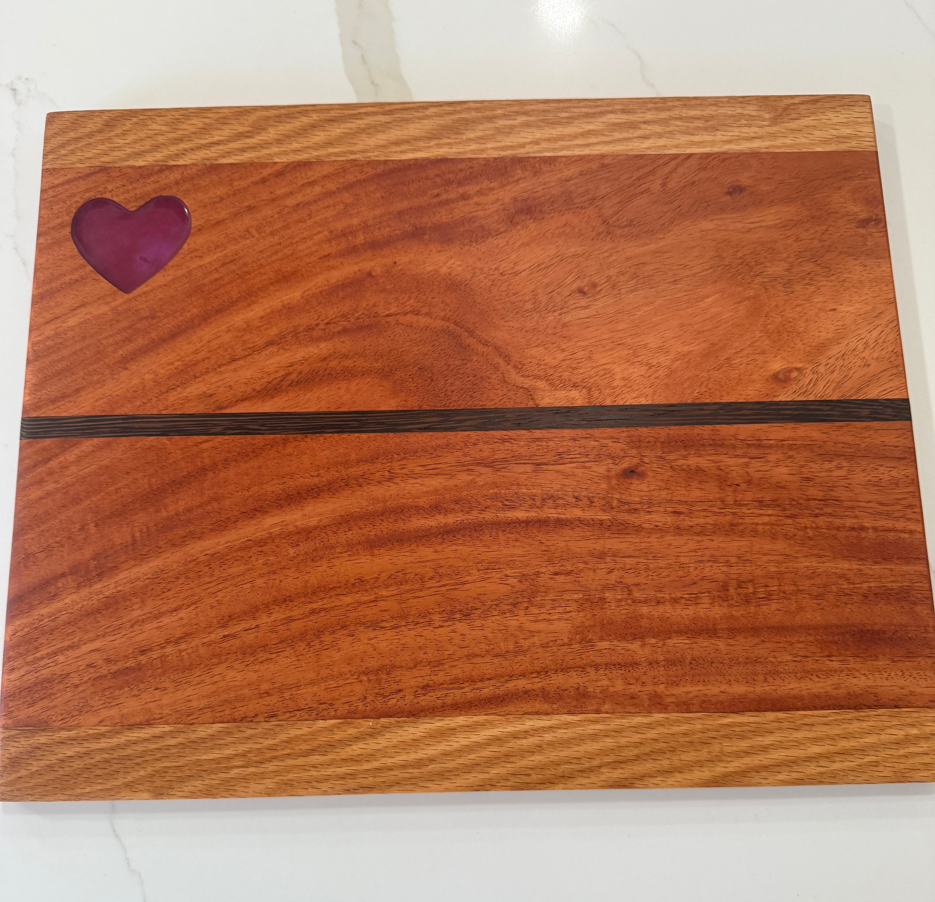 Red Heart epoxy Inlay with Padauk Wood Cutting Board, highlighted with a Strip of Wenge Wood.
