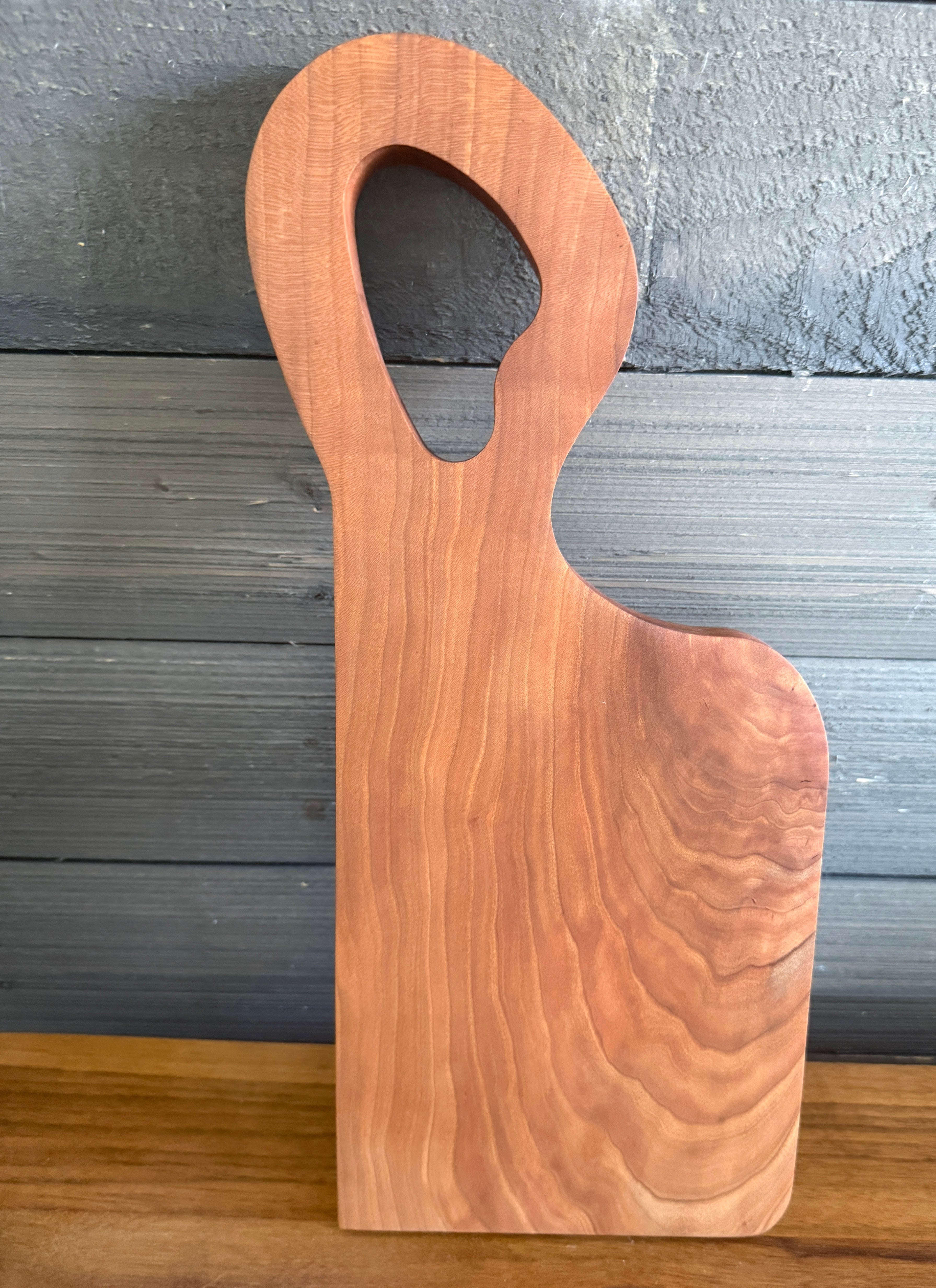 Unique offset handle with Premium Cherry Wood Cutting Board.