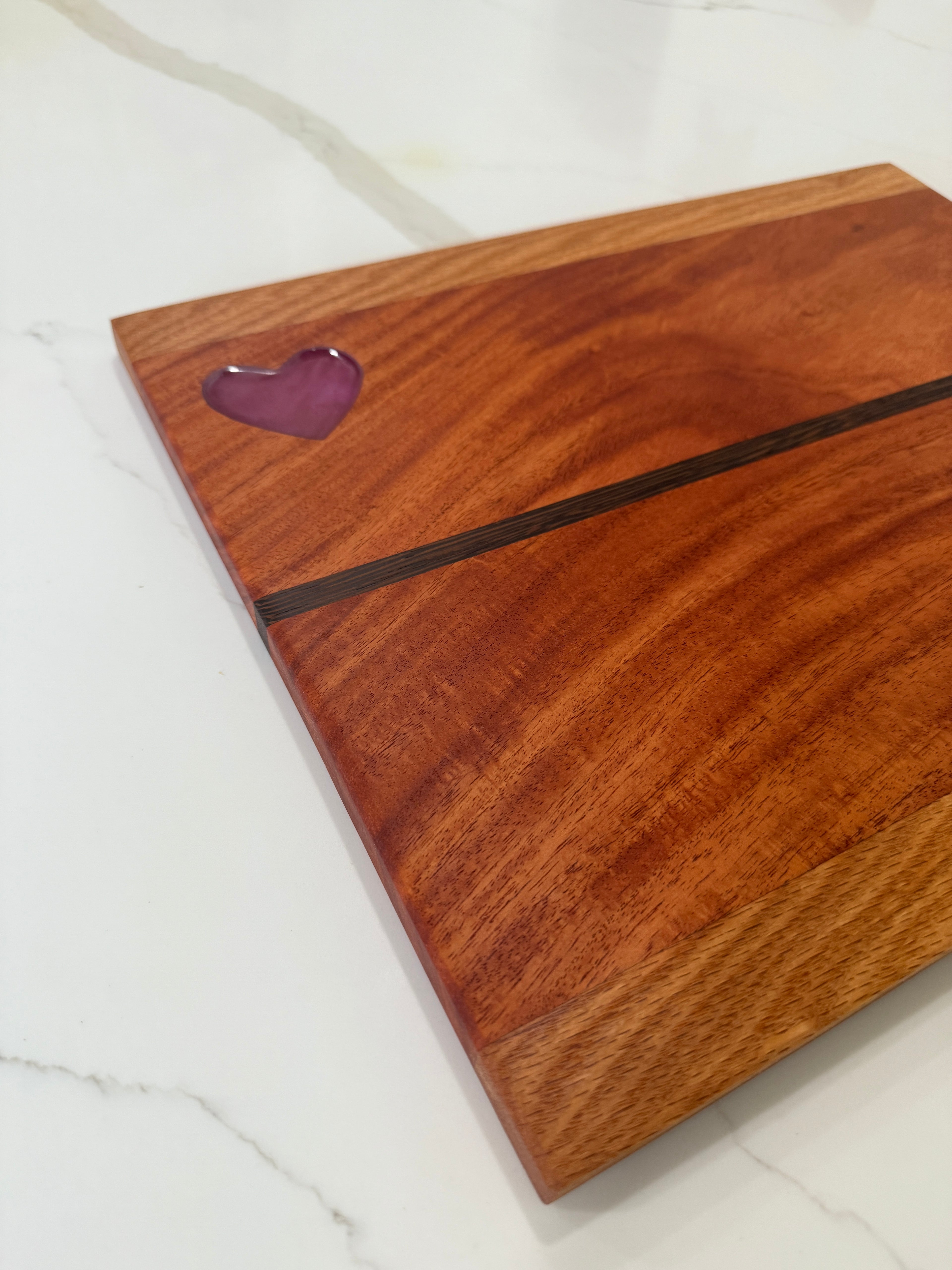 Red Heart epoxy Inlay with Padauk Wood Cutting Board, highlighted with a Strip of Wenge Wood.