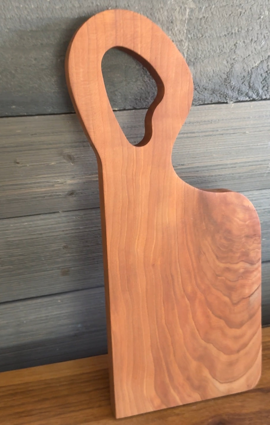 Unique offset handle with Premium Cherry Wood Cutting Board.