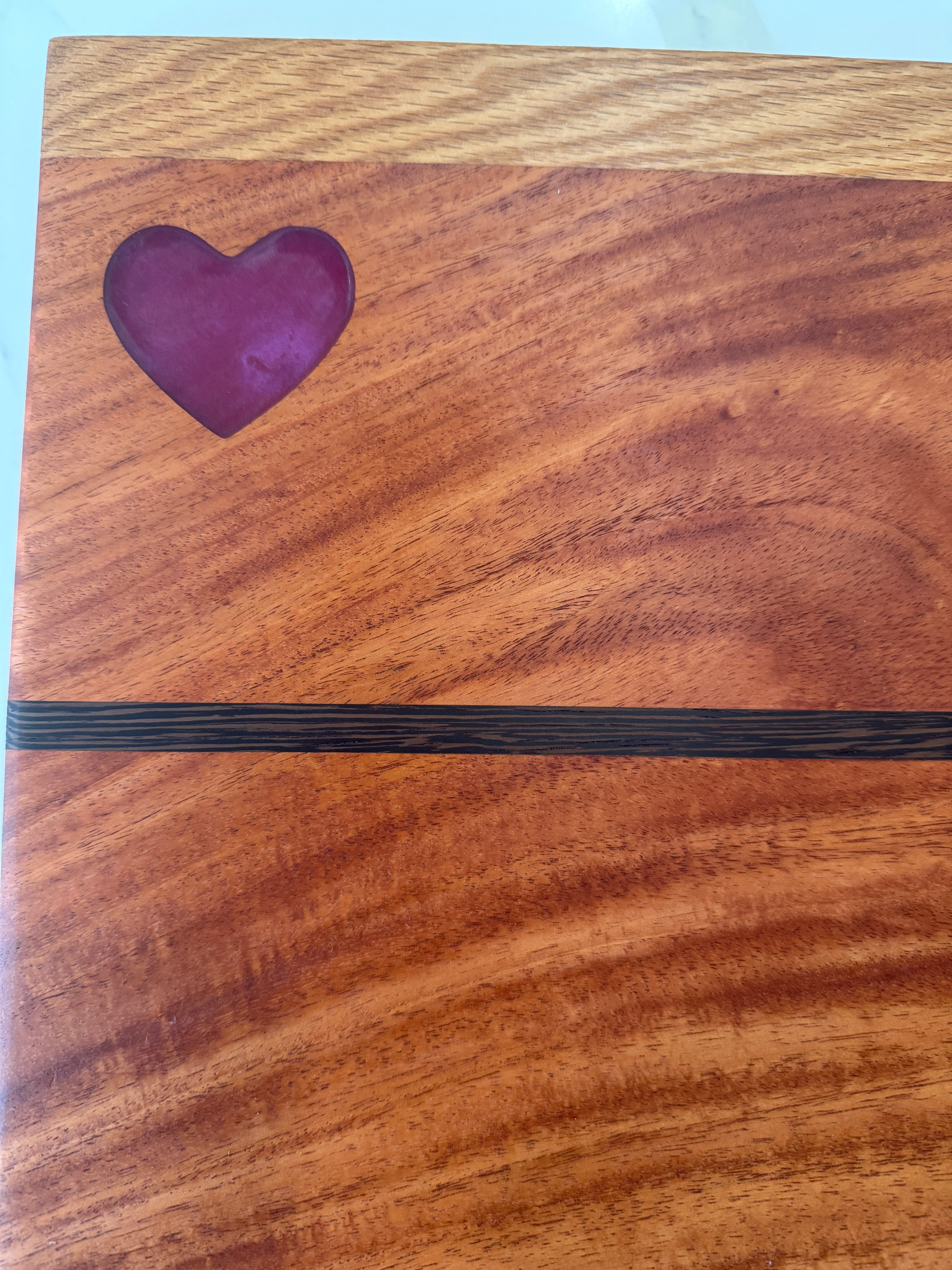 Red Heart epoxy Inlay with Padauk Wood Cutting Board, highlighted with a Strip of Wenge Wood.